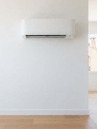 Pristine white wall with a newly installed, sleek, modern air conditioning unit, clean lines, bright Mediterranean daylight, sharp focus, 35mm