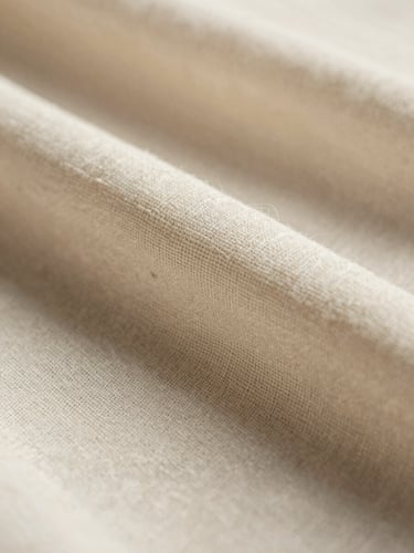 Extreme close-up macro shot of raw organic linen-silk weave, soft-directional daylight casting gentle warm shadows, showcasing pristine textile craftsmanship.