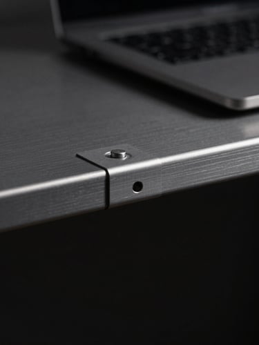 Macro detail shot of a premium anodized aluminum desk shelf, dramatic side-lighting, deep shadows, clean workspace environment, 50mm lens