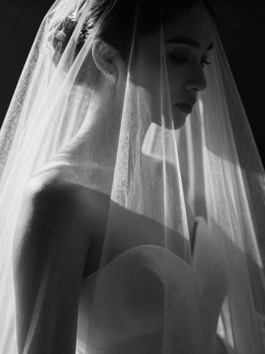 Stark black and white close-up of a bride's veil caught in a beam of harsh directional sunlight, deep geometric shadows, minimalist composition, sharp focus.
