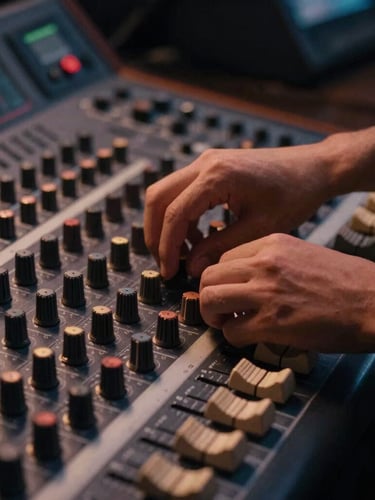 Warm low-key studio shot of hands adjusting dials on an analog mixing console, soft golden-hour light, 35mm film style.