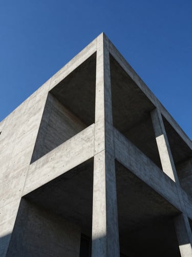 Sharp low-angle architectural photograph of a modern concrete and steel structure rising against a crisp blue sky, high-contrast shadows, professional architectural framing.