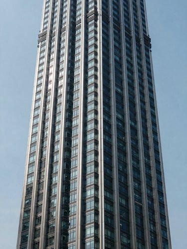 Straight-on architectural exterior of a premium KL high-rise tower under clean daylight, precise vertical lines and glazed facade geometry, no people, boardroom-grade structural clarity