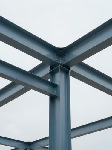 Cool architectural photography, bright overcast daylight, desaturated blue and steel tones, sharp focus, close-up of structural steel joint connection on a modern building site.