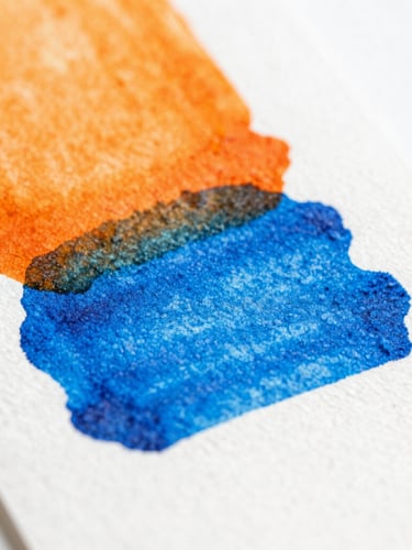 Macro detail shot of vibrant orange and electric blue ink layers drying on heavy textured cotton cardstock, bright natural daylight, 50mm lens