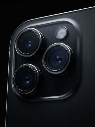 Close-up of a pristine iPhone camera lens array, sharp rim lighting highlighting the metallic curves, dark studio background, ultra-detailed textures, 85mm lens.