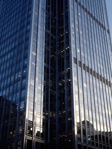 High-contrast architectural steel and glass facade of a Chicago skyscraper, sharp geometric lines, cool blue hour tones, dramatic lighting