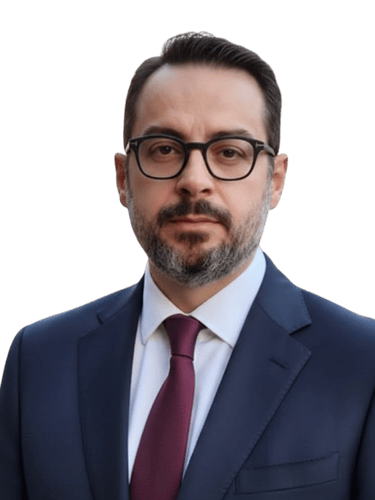 Professional portrait of a businessman wearing glasses and a navy suit with a burgundy tie.