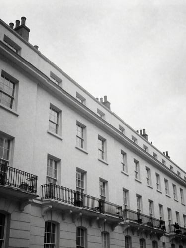 Wide-angle editorial black and white photograph of the sharp architectural lines of Silverstream House in Fitzrovia, soft overcast London daylight, high contrast, 35mm film style