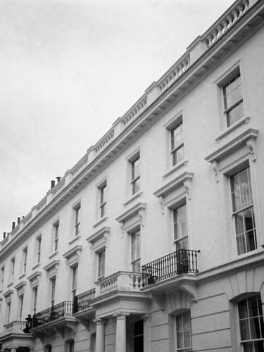 Candid black and white editorial photograph of architectural lines of Silverstream House in Fitzrovia, soft overcast London daylight, sharp shadows, 35mm film.