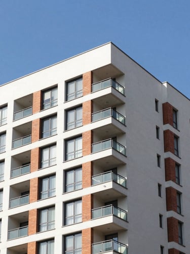 Modern residential apartment building exterior in Bogotá, crisp architectural photography, bright morning sun, clean lines, professional corporate blue sky
