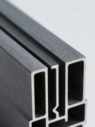 Extreme macro close-up of a seamless architectural aluminum profile joint, sharp metallic textures, dark slate gray finish, bright natural daylight highlighting precise engineering cuts, shallow depth of field.