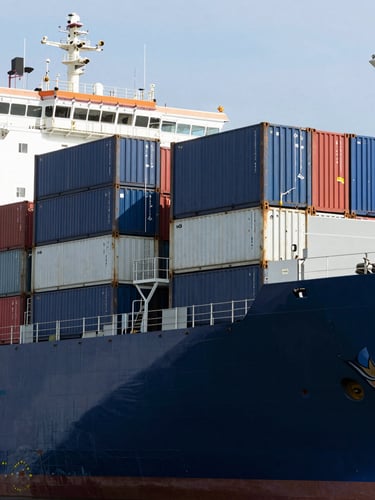 Crisp corporate logistics photography, bright daylight, container ship at the Port of Libreville, deep navy and steel tones, sharp focus, 35mm