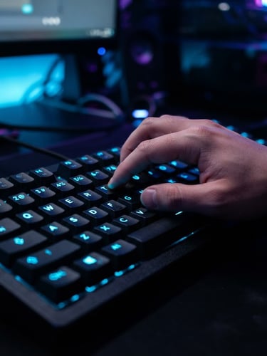 Macro close-up of a high-contrast dark keyboard with glowing neon blue legends, a hand typing a complex video generation prompt, shallow depth of field, cyber studio lighting.