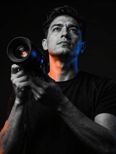 Low-angle heroic shot of a focused founder in a high-contrast black-and-white setting, dramatic low-key lighting with sharp rebel orange gel accents, 35mm lens