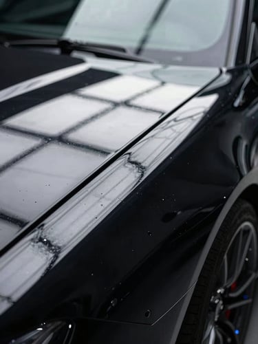 Extreme close-up of a flawless black sports car fender under bright white LED inspection grids, sharp silver reflections, high contrast chiaroscuro.