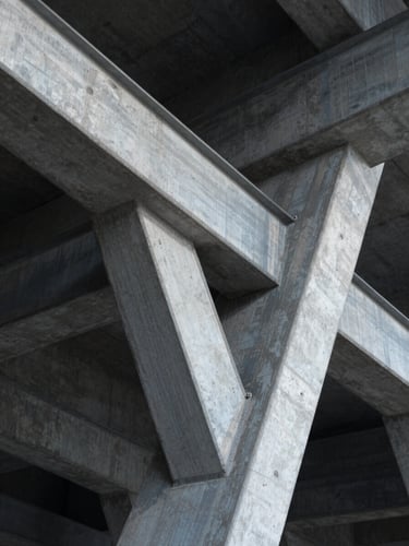 Extreme macro close-up of structural steel and concrete architectural geometry, high contrast, cool-toned studio lighting, sharp shadows, abstract mathematical pattern