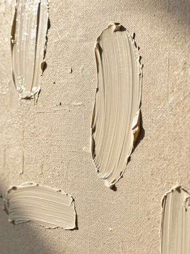Extreme macro detail shot of oil paint texture on heavy linen canvas, soft golden hour sunlight illuminating the thick impasto brushstrokes, warm alabaster tones.
