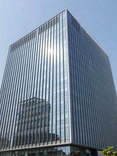 Sleek modern corporate glass facade in Gurgaon business district, clean architectural lines, bright natural daylight, wide-angle 35mm photography