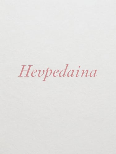 Overhead flat-lay of heavy-weight cotton paper stock with elegant printed serif typography, soft natural daylight, minimalist aesthetic.
