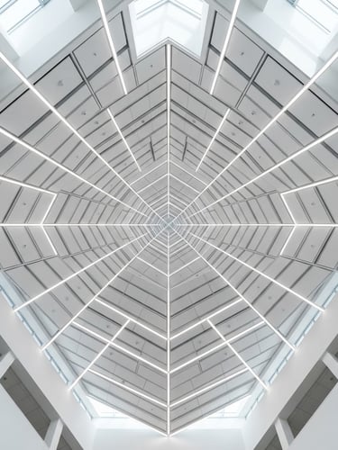 Symmetrical low-angle architectural photograph looking up at a perfectly aligned modular white ceiling with integrated linear LED lighting, sharp focus, bright natural daylight, grey shadows, minimalist style