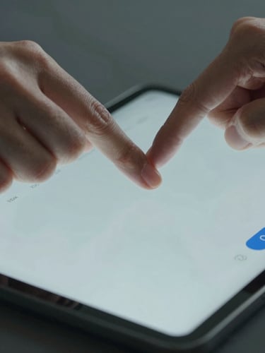 Tight macro shot of hands interacting with a clean digital dashboard on a tablet, natural cool-toned daylight, high-clarity interface.