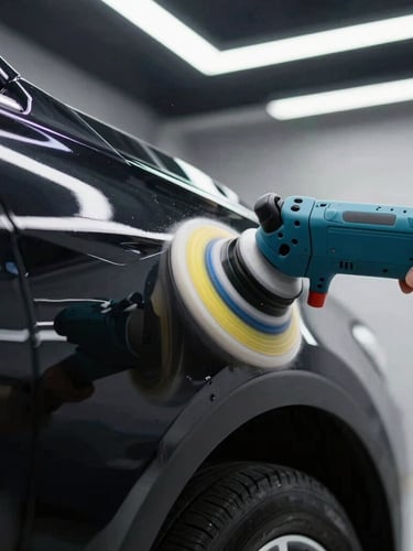 Extreme close-up of a dual-action polisher being guided across a flawlessly corrected black car fender, bright overhead LED strip reflections, sharp automotive photography