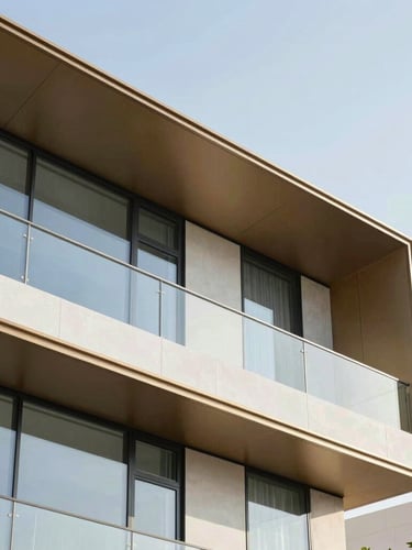 Bright high-key architectural detail of a premium modern villa in Dubai Hills, sharp geometric angles, soft daylight reflecting off glass, 35mm editorial corporate photography