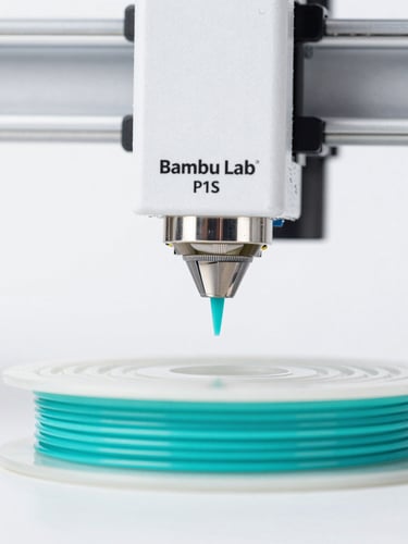 Macro photograph of a Bambu Lab P1S 3D printer nozzle extruding bright turquoise filament, sharp details, clean studio lighting, high contrast