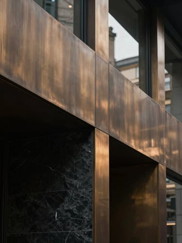 Minimalist architectural detail of a private office in London, sharp angles of brushed bronze and dark slate, low-key indirect natural light, cinematic composition