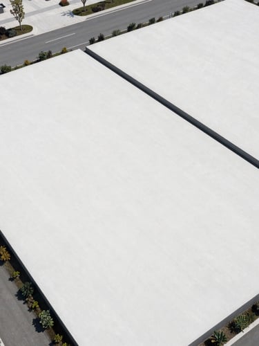 Aerial view of a clean, structured land development plot, bright natural daylight, high contrast, sharp boundaries, professional composition.