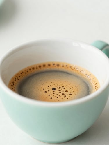 Macro shot of espresso extraction, bright minimalist lighting, soft natural daylight, mint green and warm white tones, shallow depth of field, 35mm