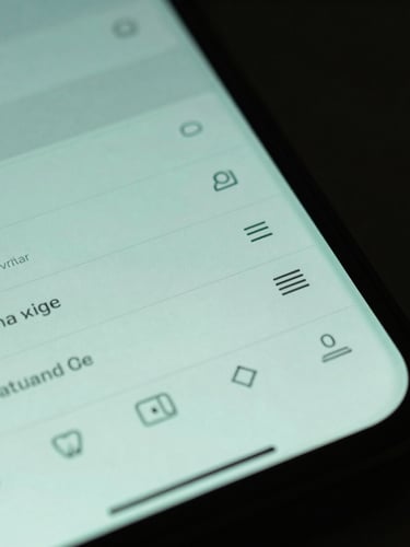 Macro close-up of a physical Android smartphone screen displaying custom interface details, low-key studio lighting with soft mint-green glow reflecting off glass, dark background