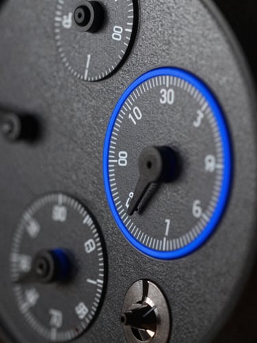 Macro side-view of a custom instrument-grade panel with precise mechanical dials, dark matte surface, sharp blue rim lighting.