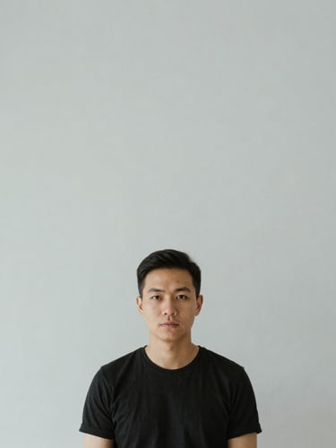 Minimalist editorial portrait of a developer in natural light, clean studio environment, neutral background, sharp focus, desaturated cool tones, 35mm lens.