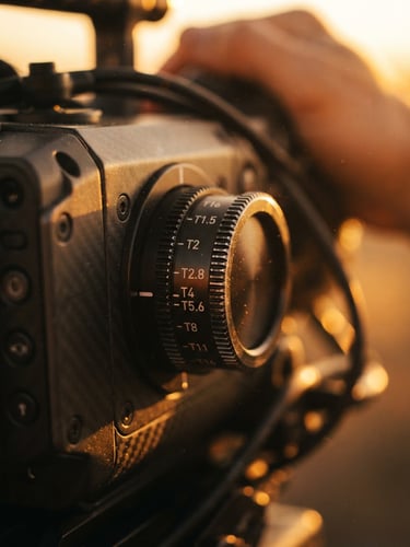 Extreme close-up of a high-end cinema camera dial, golden hour backlighting, rich warm tones, shallow depth of field, 35mm lens.