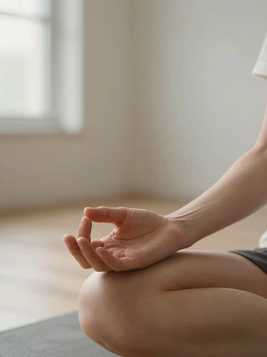 Extreme close-up of hands resting open on knees during seated meditation, soft morning light from a window at left, warm skin tones against a pale minimalist background, calm and deliberate stillness