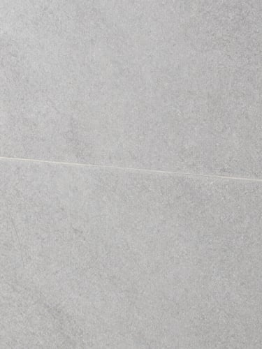 Macro close-up of premium textured grey porcelain tile, sharp focus on glaze detail, neutral studio lighting, architectural minimalist style