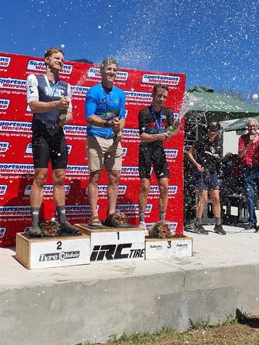 Cycling coach Andre on podium at Sportsmans Warehouse mountain bike race.