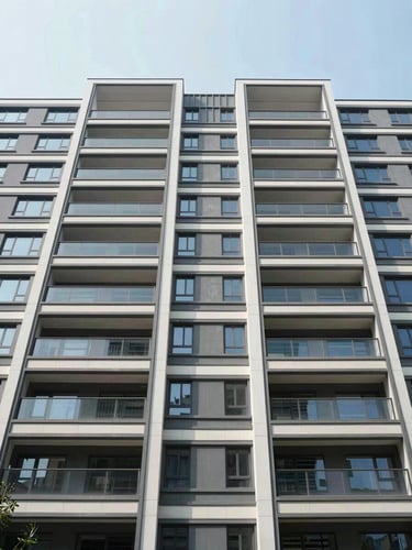 Symmetrical wide-angle architectural shot of a modern multi-family residential building exterior with clean lines under bright, diffused daylight.