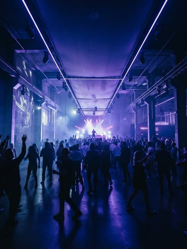 Wide panoramic shot of an immersive event space, dramatic architectural lighting in deep indigo and electric violet, silhouettes of guests in motion, high-contrast and moody ambient light, cinematic lens.