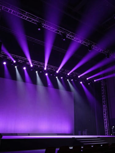 Extreme wide-angle shot of a massive, custom-built corporate stage illuminated by sharp violet spotlights, deep shadows, structural metal trusses visible, raw industrial scale.