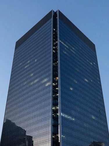 Wide panoramic shot of a modern high-rise corporate office building in São Paulo at dusk, architectural glass and steel reflecting deep blue light, sharp angles, minimalist aesthetic.