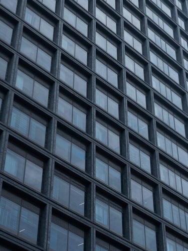 Macro shot of clean architectural lines of a modern corporate skyscraper in São Paulo, deep blue and slate tones, cool diffused daylight, sharp focus, 35mm