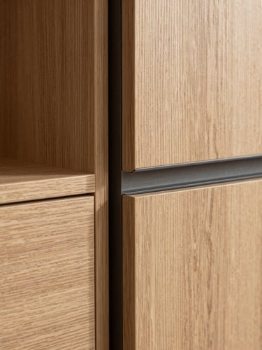 Crisp architectural detail shot of a custom oak wardrobe corner, showing a flush miter joint meeting a dark steel frame under soft natural daylight, sharp shadows, high-contrast.