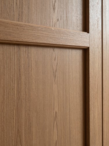 Close-up of premium oak wood panel texture, soft natural side-light highlighting the 3D relief, warm architectural photography style