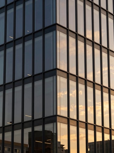 Architectural lines of a modern office building in Ponta Grossa, warm sunset light reflecting on glass panels, clean geometric composition