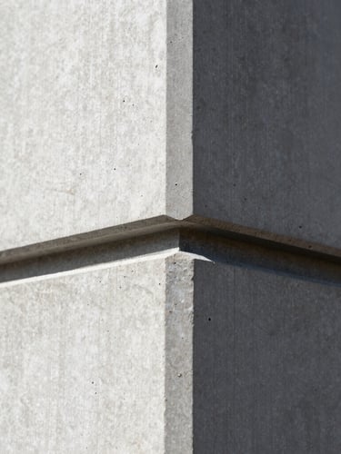 Extreme close-up of a perfectly flush drywall bead meeting a raw steel structural column, sharp focus, high contrast, architectural detail