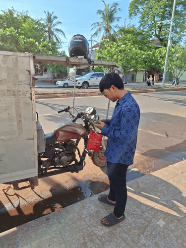 alt="Local courier preparing an Angkor Herbal Solutions package order for fast local shipping"