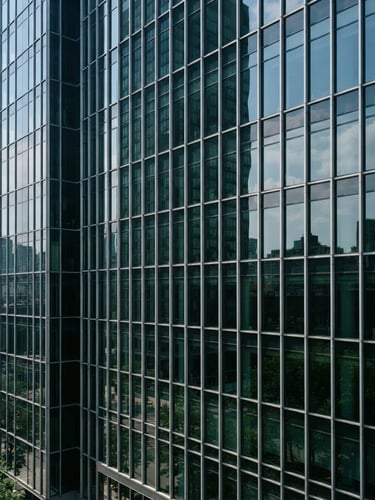 Crisp architectural view of a modern glass office building facade, clean technical daylight, metallic reflections, deep green tones, 35mm
